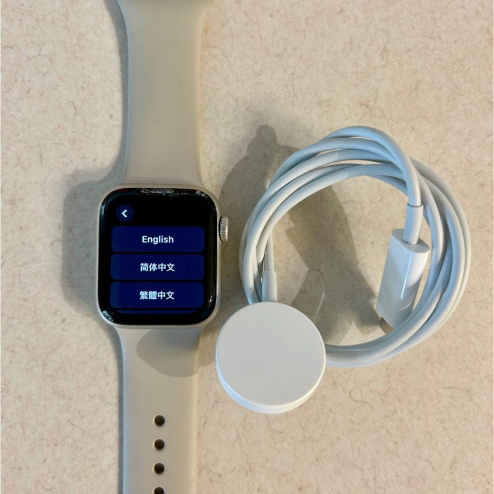 Apple Watch SE with sand color sport band- **has chipped glass**